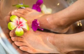 person's feet with flowers